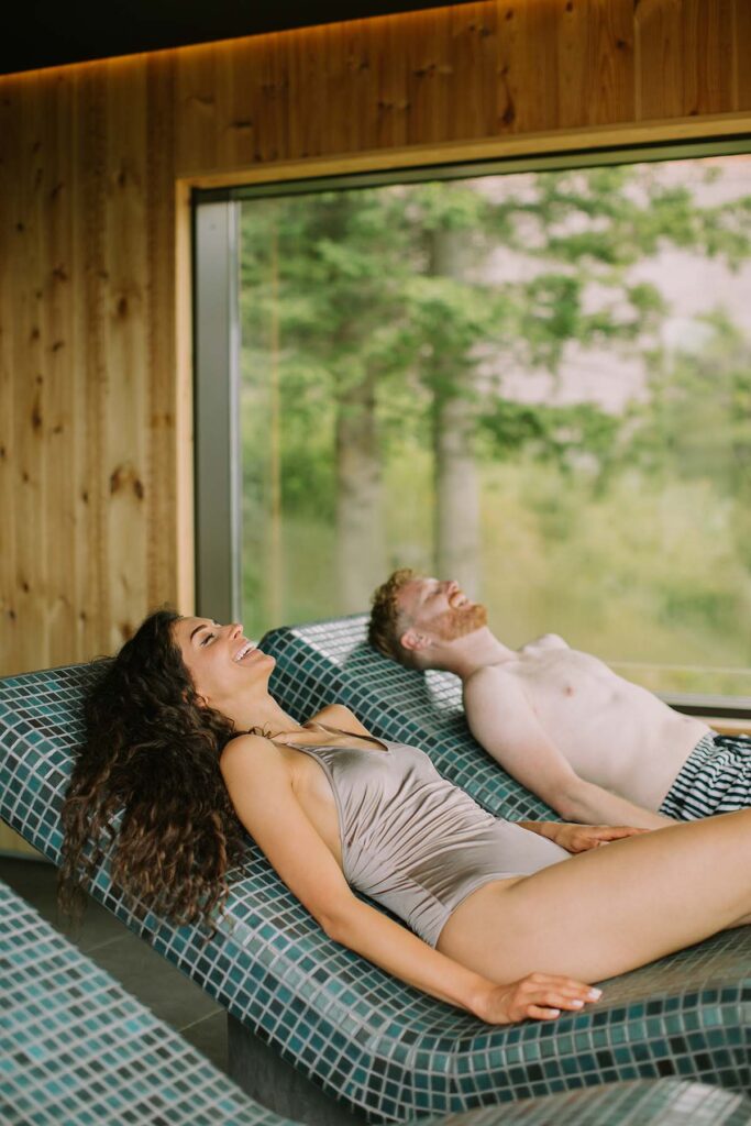 young-couple-relaxing-on-the-tepidarium-bed-in-the-KSPPWQB.jpg